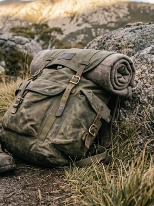 A loaded waxed-canvas expedition pack against granite